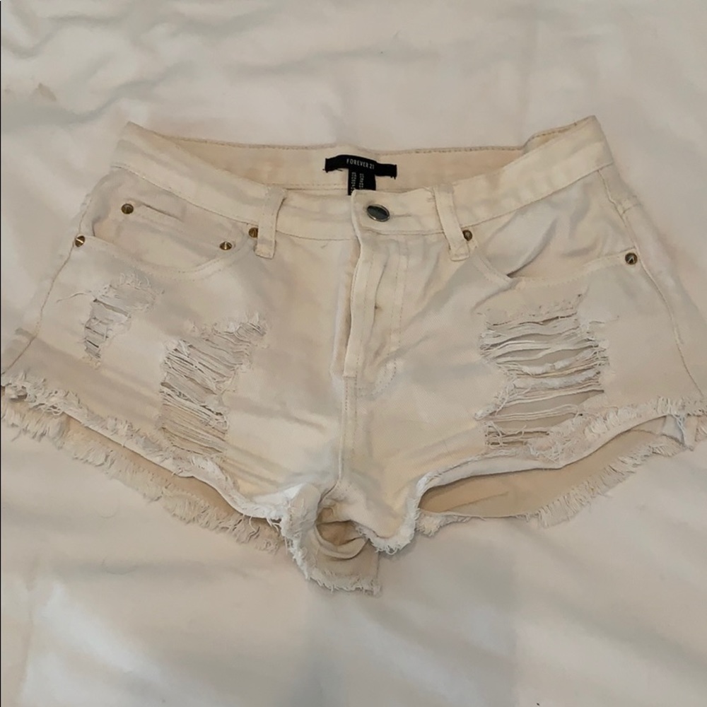 Distressed white jean shorts